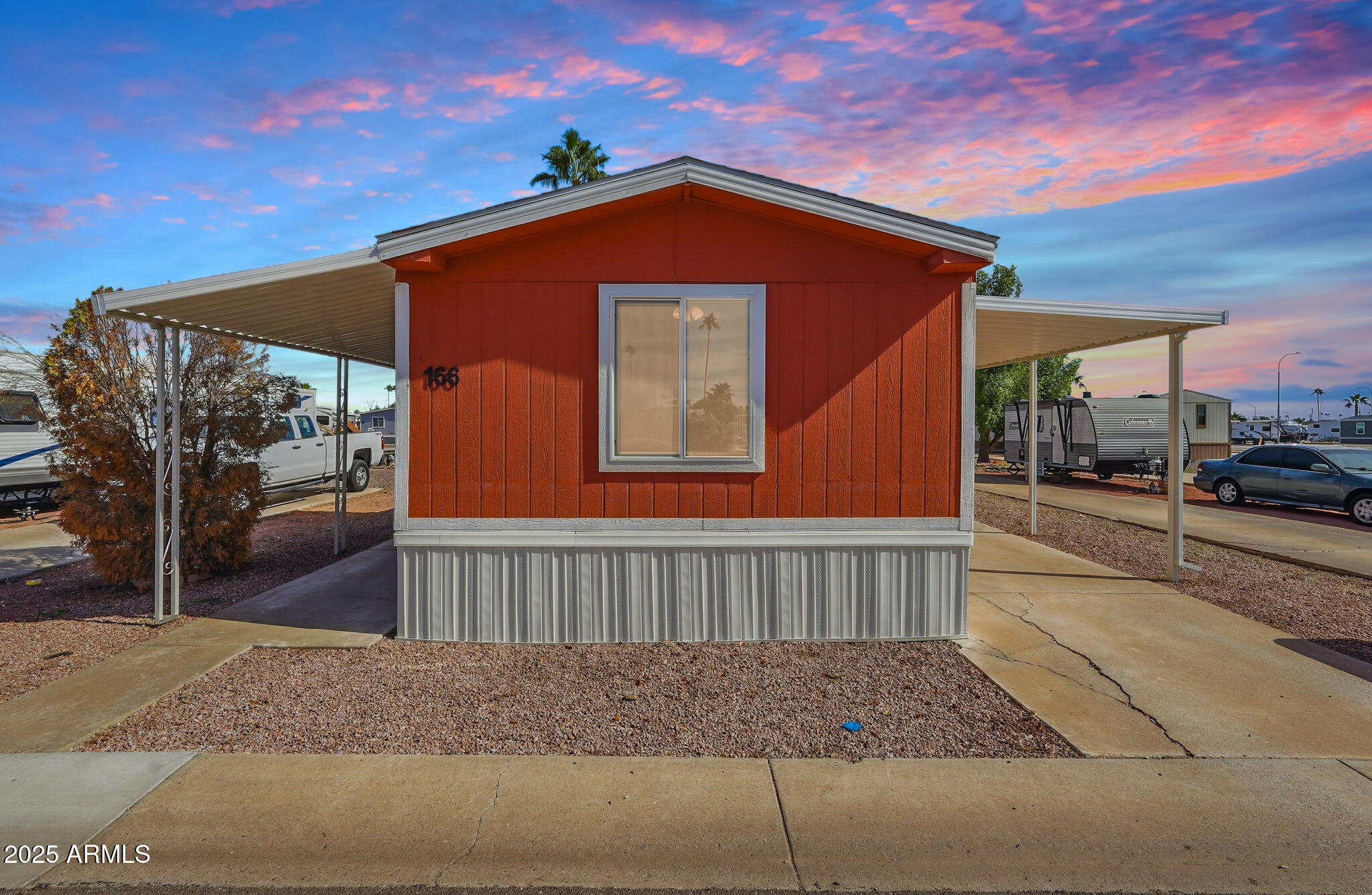 320 East McKellips Road, Unit 166 Mesa, AZ 85201 - Photo 2 of 24 a front view of a house with a yard