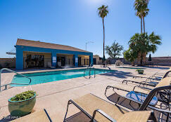 320 East McKellips Road, Unit 166 Mesa, AZ 85201 - Photo 21 of 24 a view of a house with a swimming pool and a fire pit