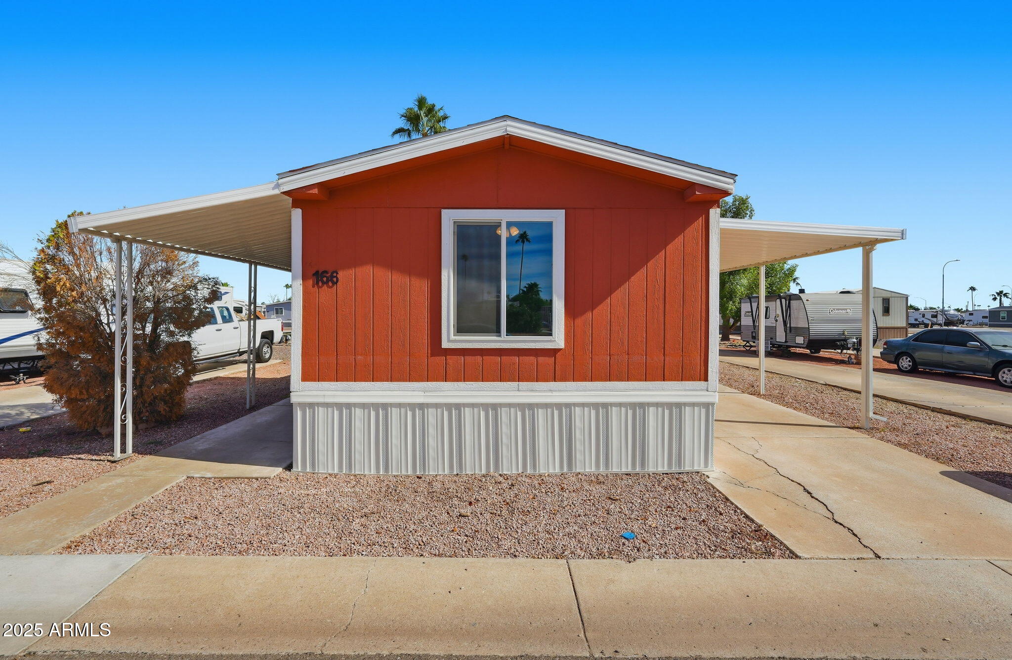 320 East McKellips Road, Unit 166 Mesa, AZ 85201 - Photo 23 of 24 a front view of a house with a yard
