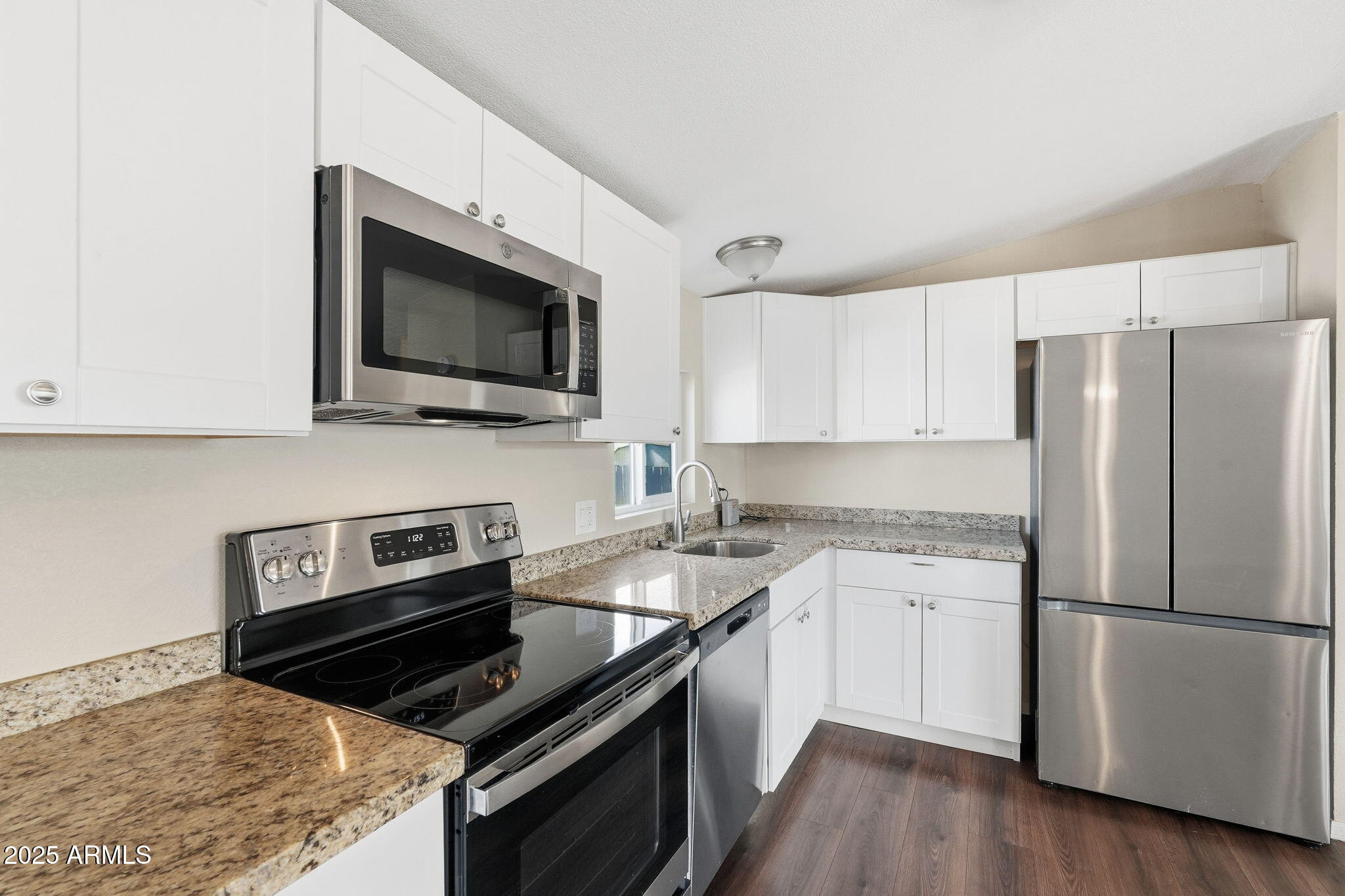 320 East McKellips Road, Unit 166 Mesa, AZ 85201 - Photo 3 of 24 a kitchen with a stove microwave and refrigerator