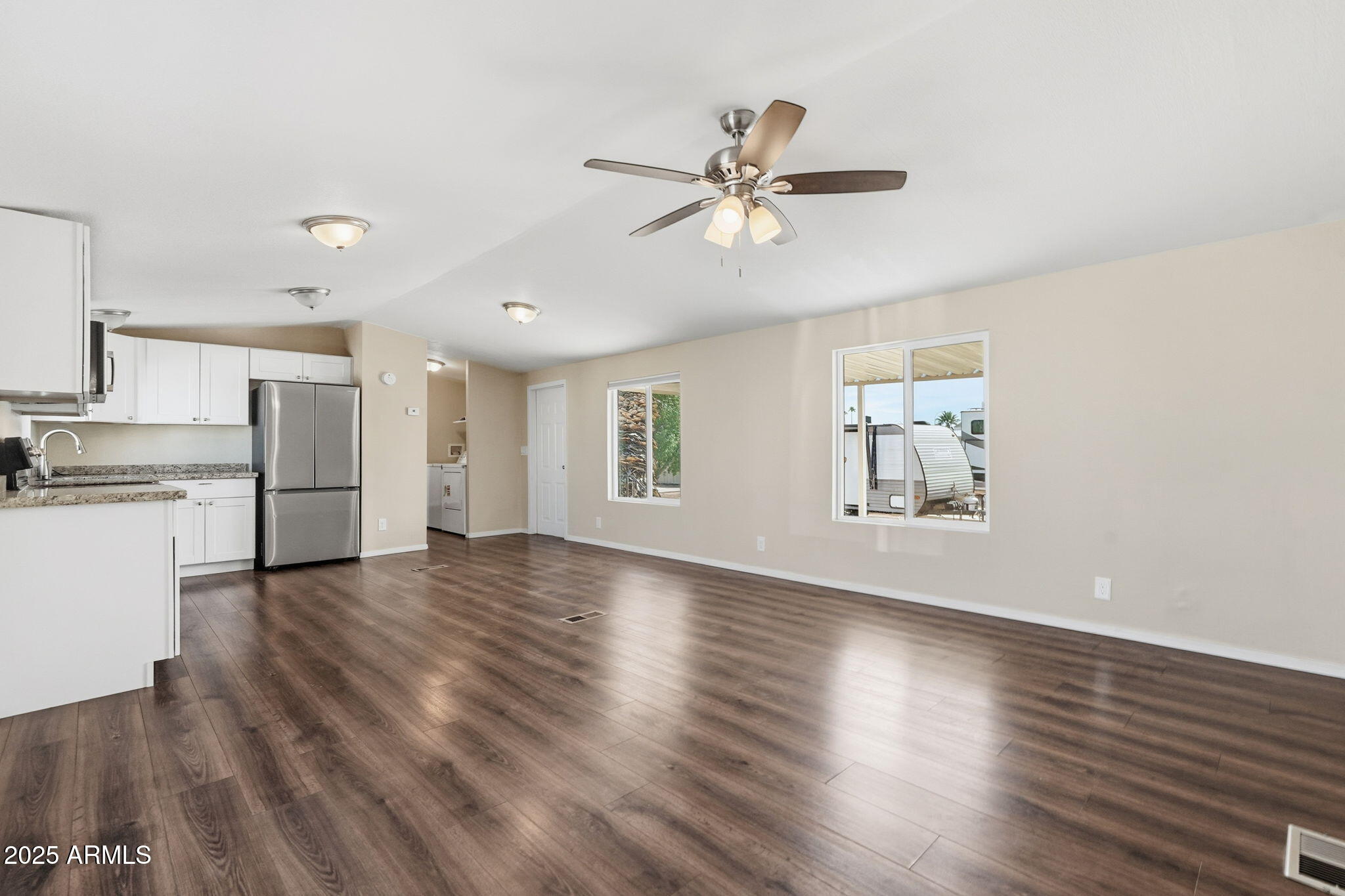 320 East McKellips Road, Unit 166 Mesa, AZ 85201 - Photo 9 of 24 a view of empty room with wooden floor and window