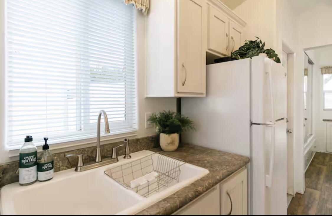 74711 Dillon Road Desert Hot Springs, CA 92241 - Photo 13 of 60 a kitchen with a sink appliances and a window