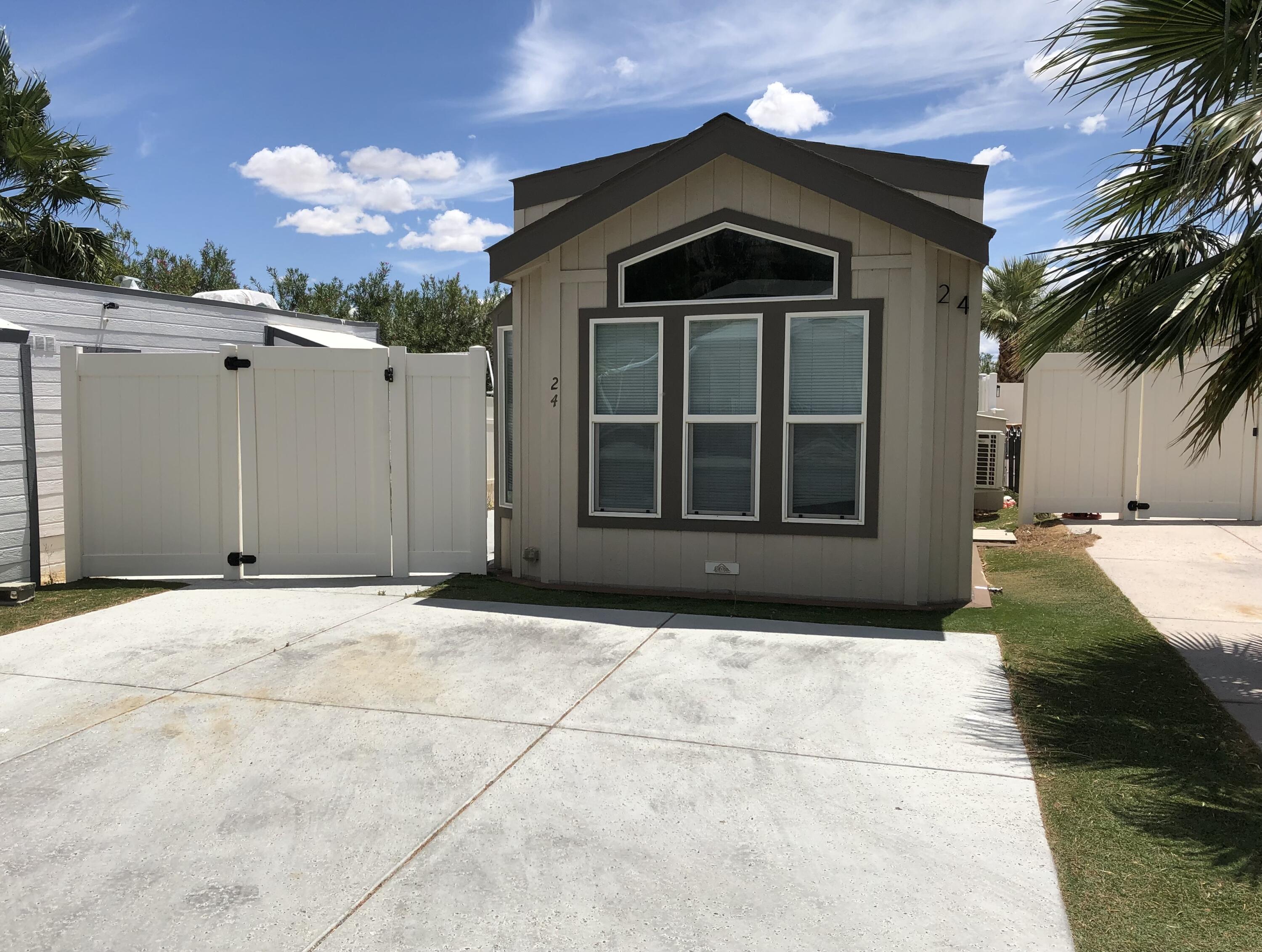 74711 Dillon Road Desert Hot Springs, CA 92241 - Photo 2 of 60 a front view of a house with a yard