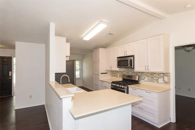 a kitchen that has a cabinets and a stove
