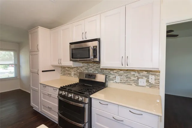 a kitchen with a stove and a microwave