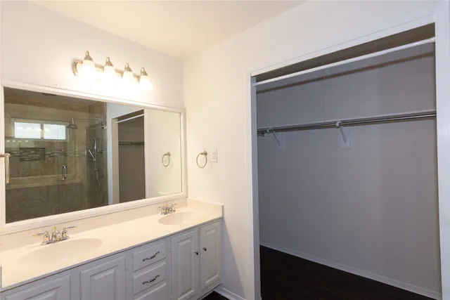 a bathroom with a granite countertop sink mirror and double