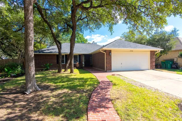 a front view of a house with a yard and porch