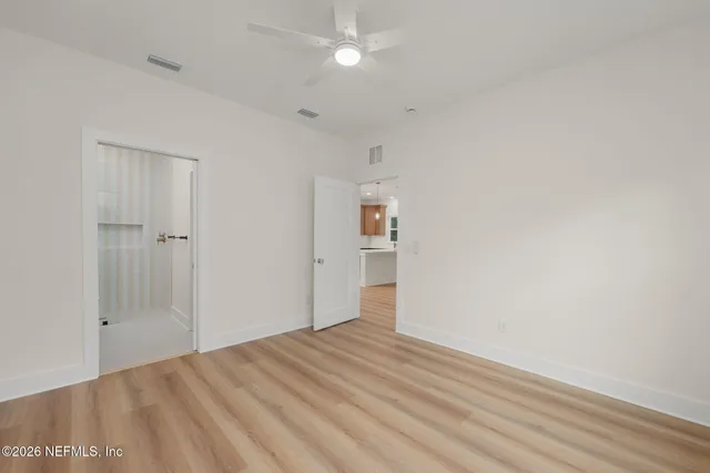 a bathroom with a sink a toilet a mirror and shower