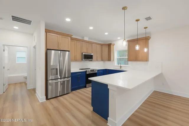 a kitchen with a sink and wooden cabinets