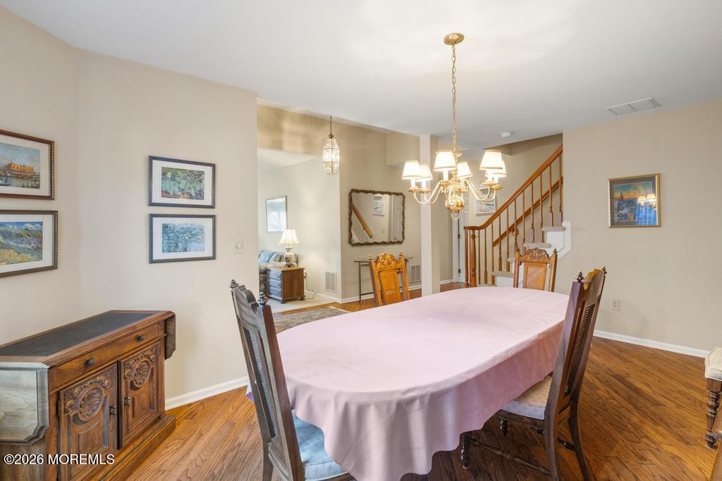2287 Coral Leaf Road Toms River, NJ 08755 - Photo 11 of 38 a view of a dining room with furniture and a chandelier