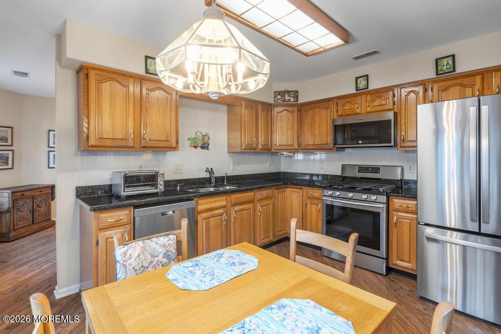 2287 Coral Leaf Road Toms River, NJ 08755 - Photo 13 of 38 a kitchen with stainless steel appliances a stove a sink refrigerator and a microwave
