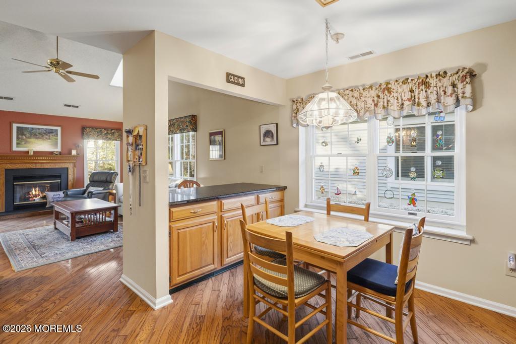 2287 Coral Leaf Road Toms River, NJ 08755 - Photo 15 of 38 a dining room with a wooden table and chairs