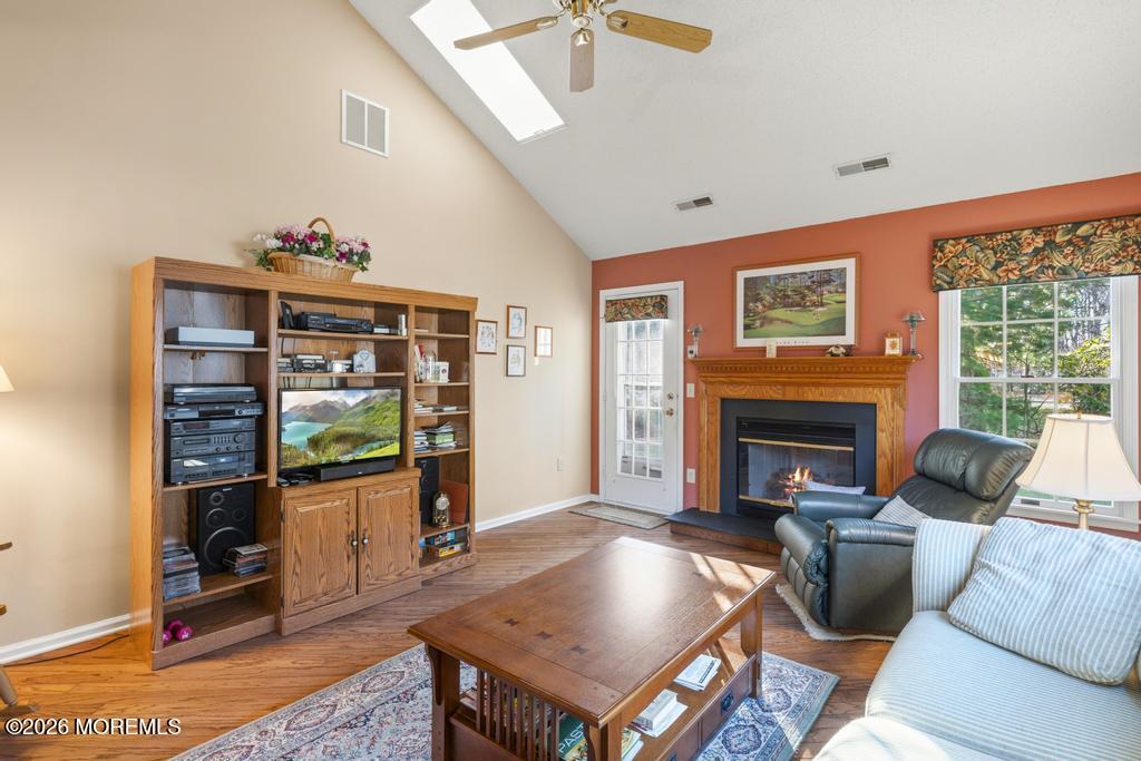 2287 Coral Leaf Road Toms River, NJ 08755 - Photo 18 of 38 a living room with furniture a flat screen tv and a fireplace