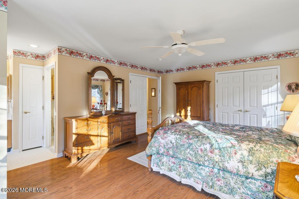 2287 Coral Leaf Road Toms River, NJ 08755 - Photo 22 of 38 a spacious bedroom with a bed a dresser and windows