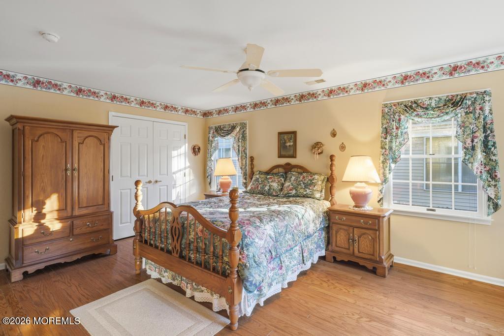 2287 Coral Leaf Road Toms River, NJ 08755 - Photo 23 of 38 a bedroom with a bed and a chandelier