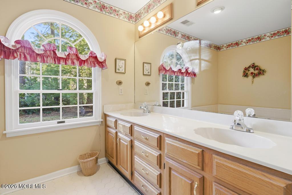 2287 Coral Leaf Road Toms River, NJ 08755 - Photo 24 of 38 a bathroom with a sink mirror and a window