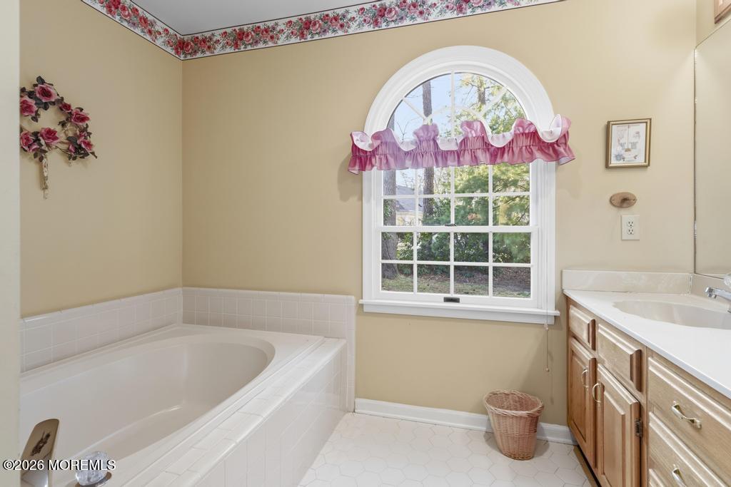 2287 Coral Leaf Road Toms River, NJ 08755 - Photo 25 of 38 a bathroom with a sink a vanity and a bathtub