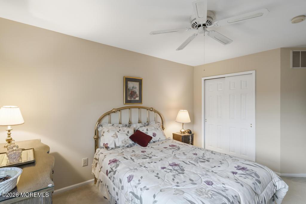 2287 Coral Leaf Road Toms River, NJ 08755 - Photo 35 of 38 a bedroom with a bed and a chandelier