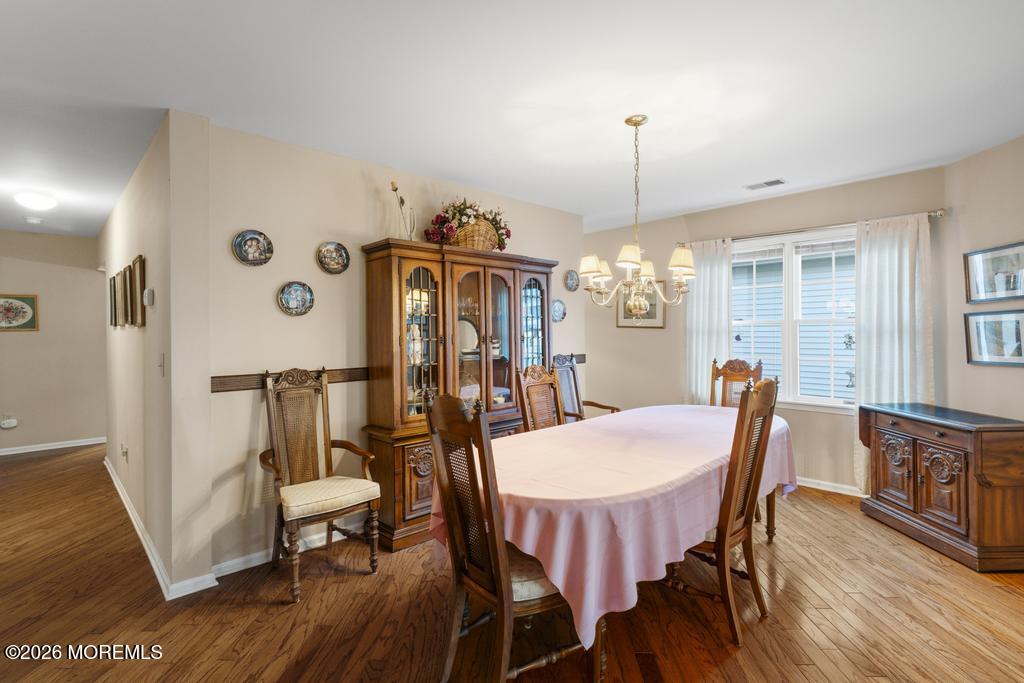 2287 Coral Leaf Road Toms River, NJ 08755 - Photo 8 of 38 a view of a dining room with furniture window and wooden floor