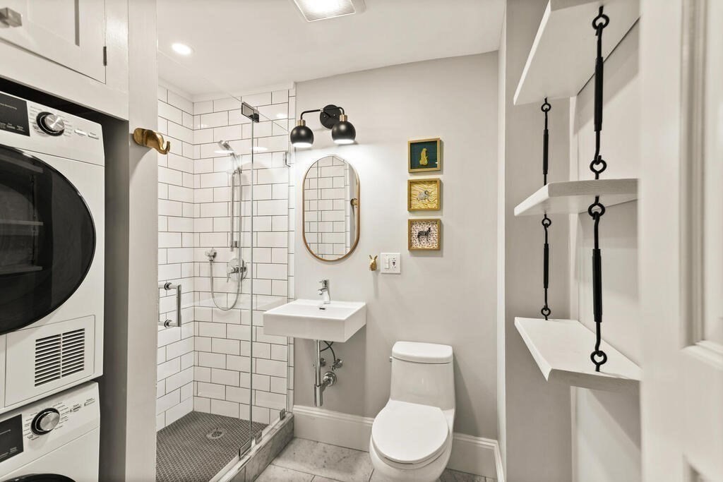 473 Beacon Street, Unit 5 Boston, MA 02115 - Photo 7 of 21 a bathroom with a toilet sink a mirror a shower and vanity