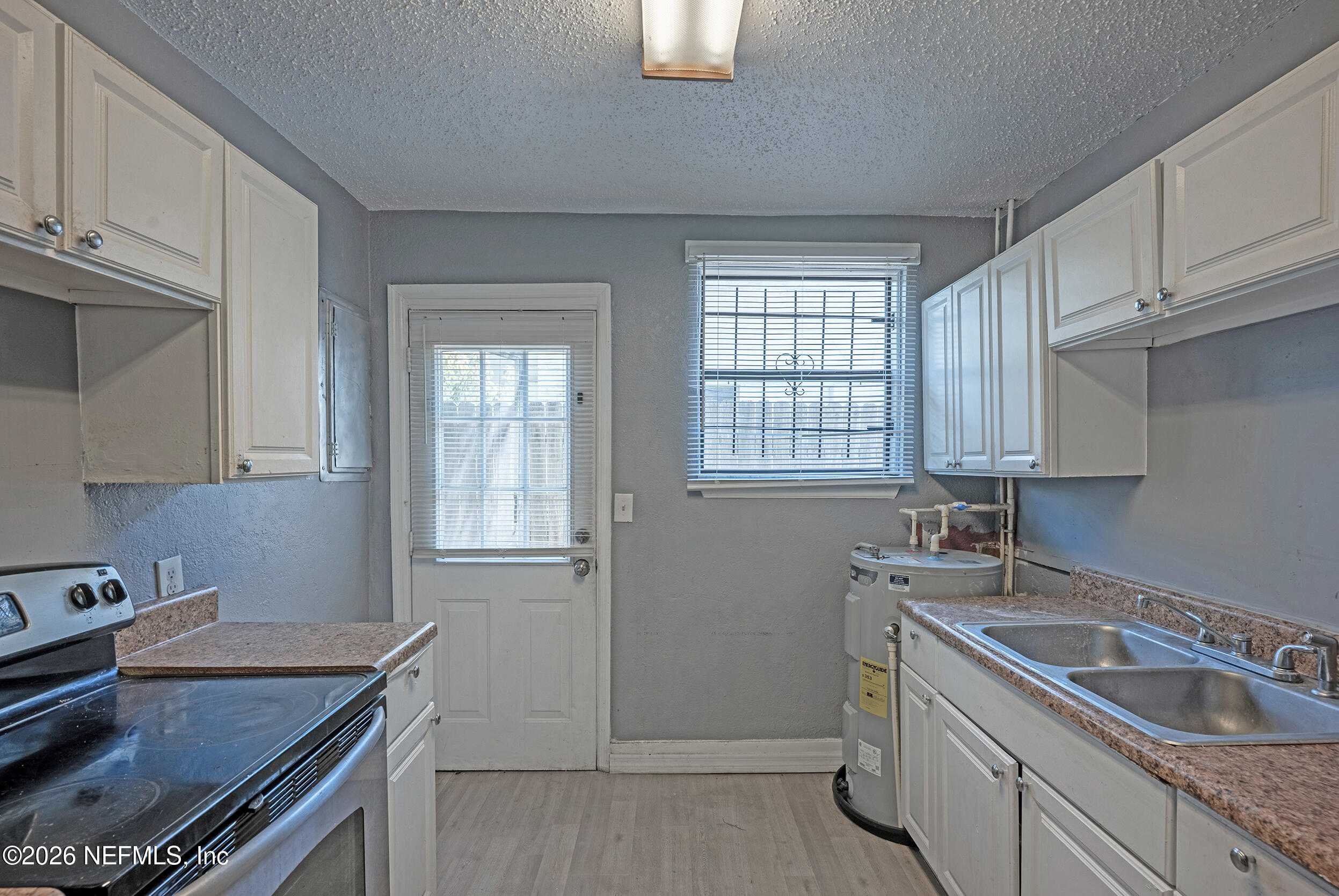 4114 Moncrief Road Jacksonville, FL 32209 - Photo 12 of 42 a kitchen with a sink stove top oven and cabinets