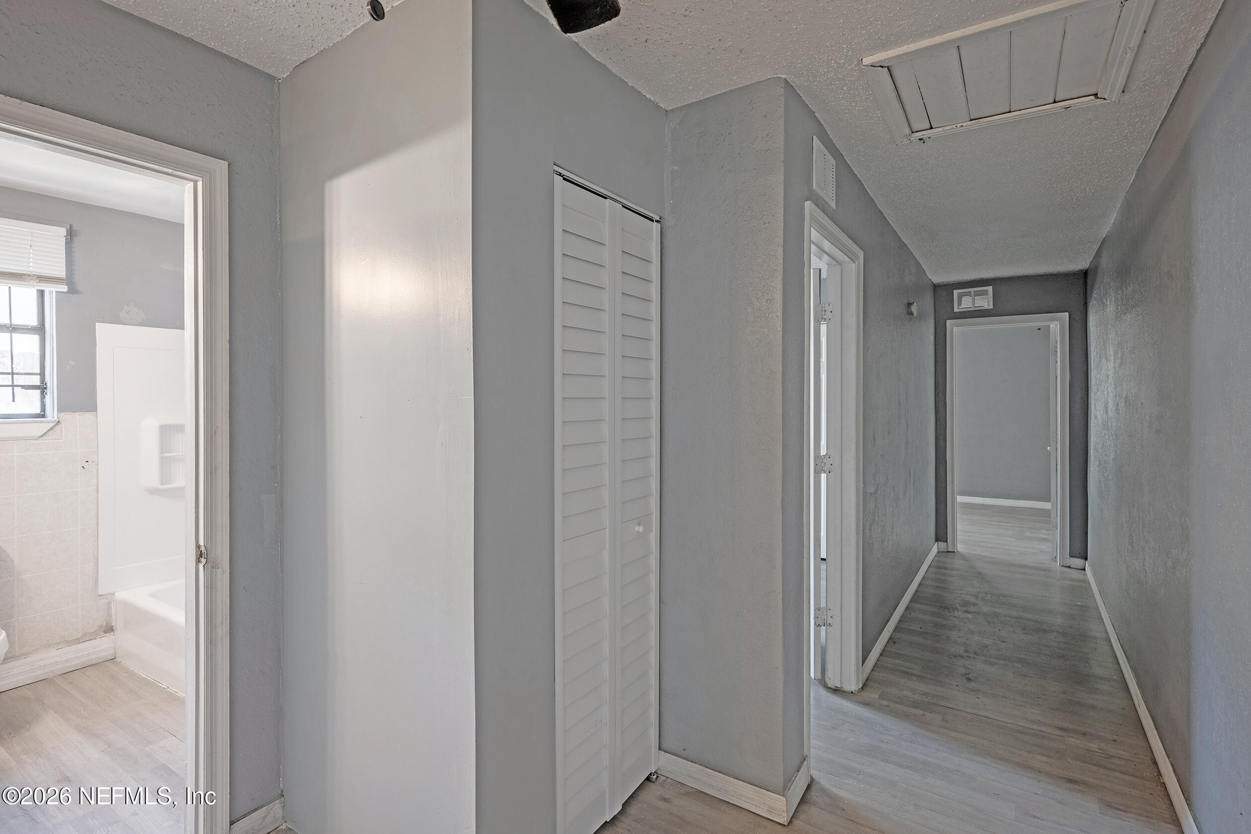 4114 Moncrief Road Jacksonville, FL 32209 - Photo 18 of 42 a view of a hallway with wooden floor and closet