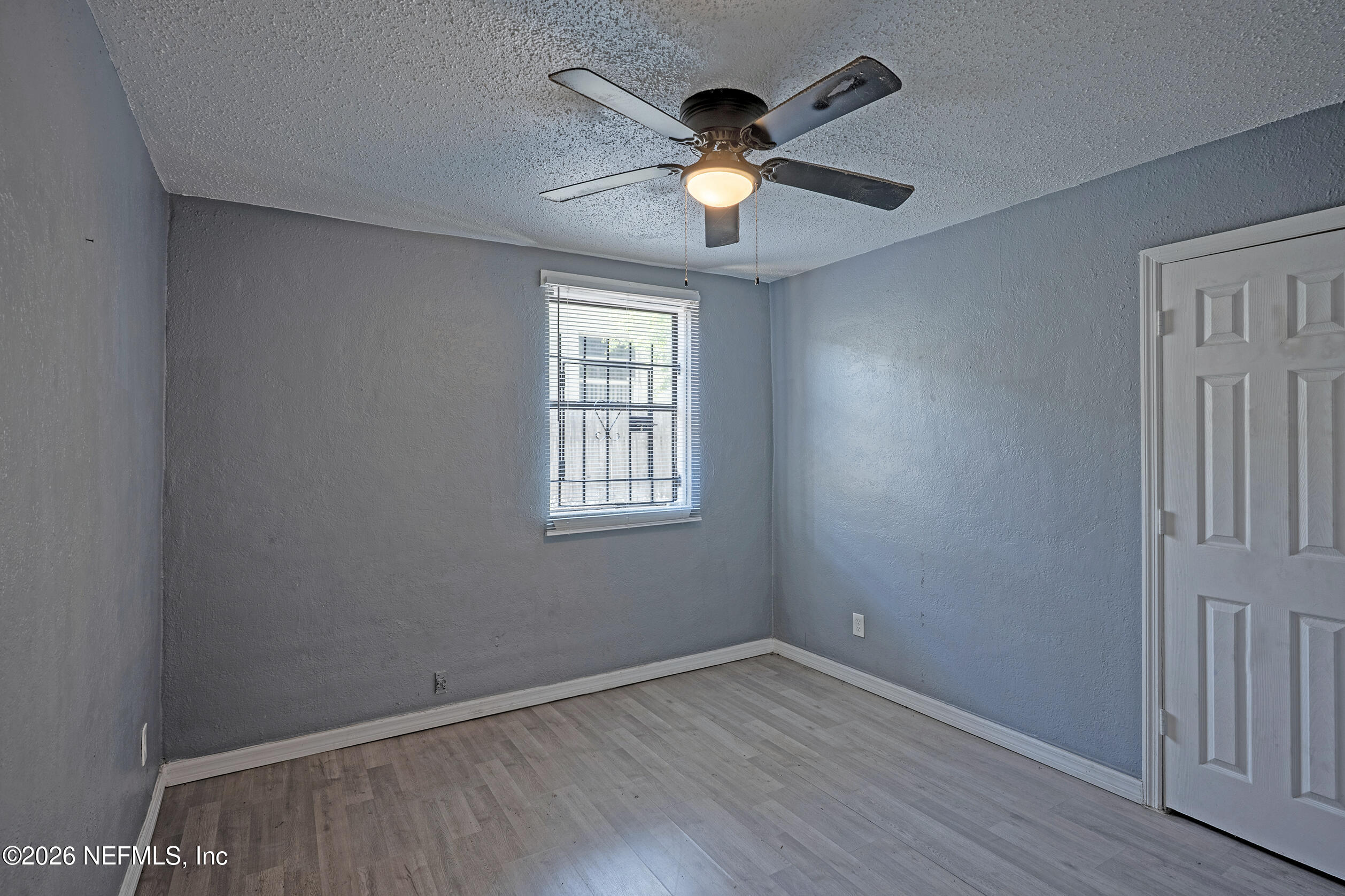 4114 Moncrief Road Jacksonville, FL 32209 - Photo 19 of 42 an empty room with wooden floor and windows