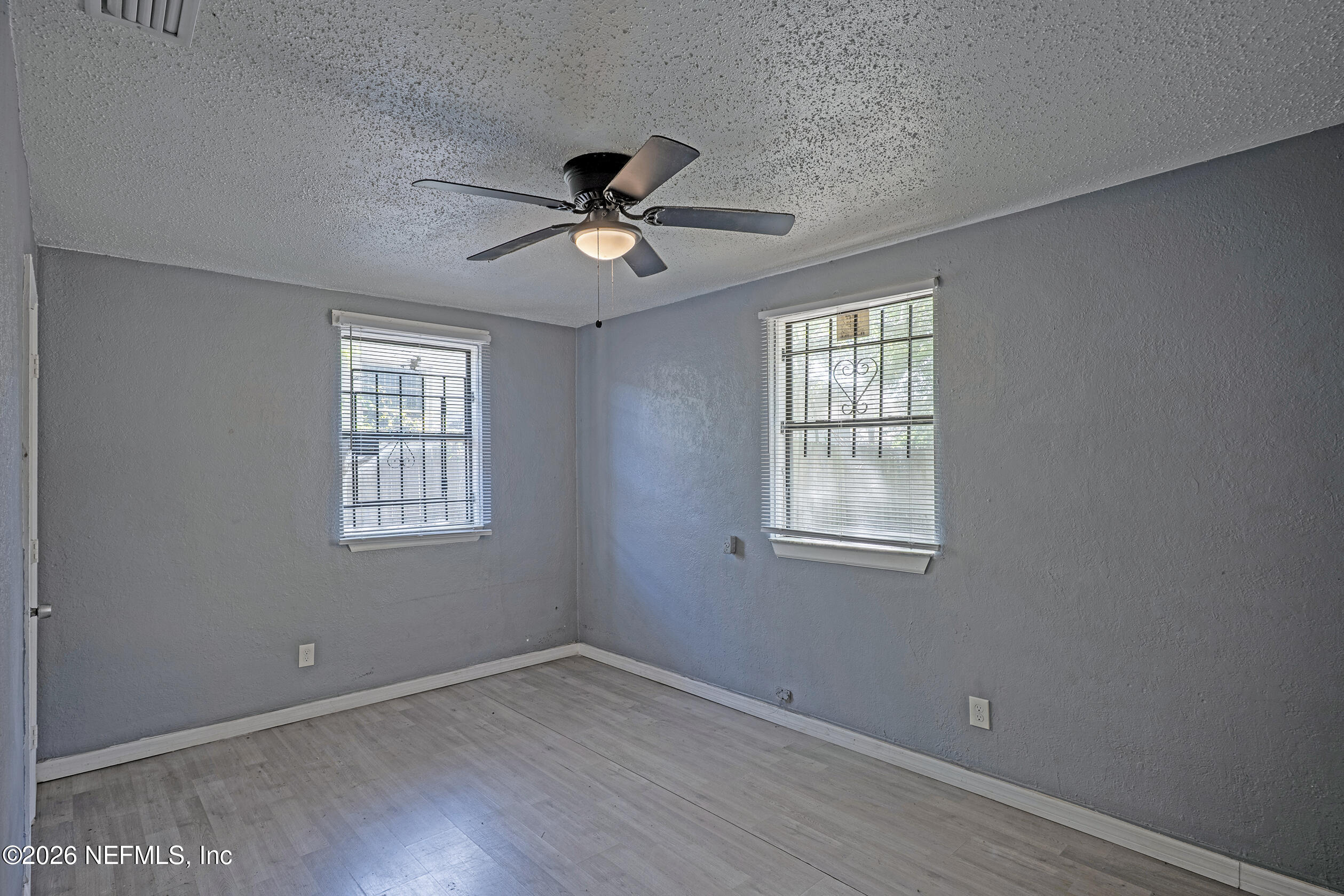 4114 Moncrief Road Jacksonville, FL 32209 - Photo 21 of 42 a view of empty room with wooden floor and fan