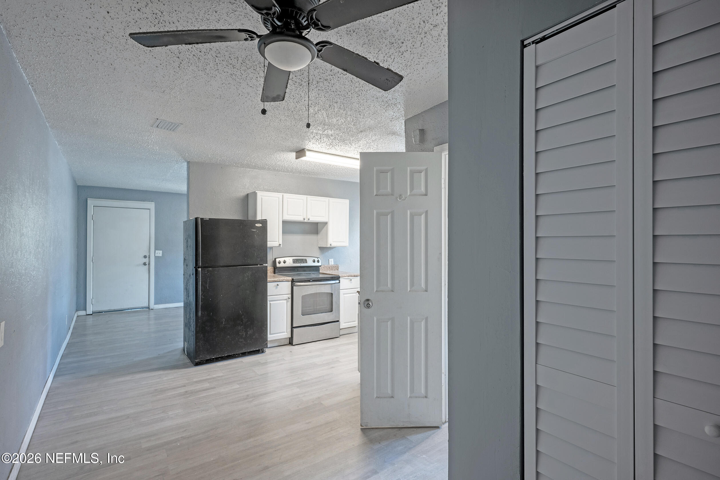 4114 Moncrief Road Jacksonville, FL 32209 - Photo 24 of 42 a view of a refrigerator in kitchen and an empty room