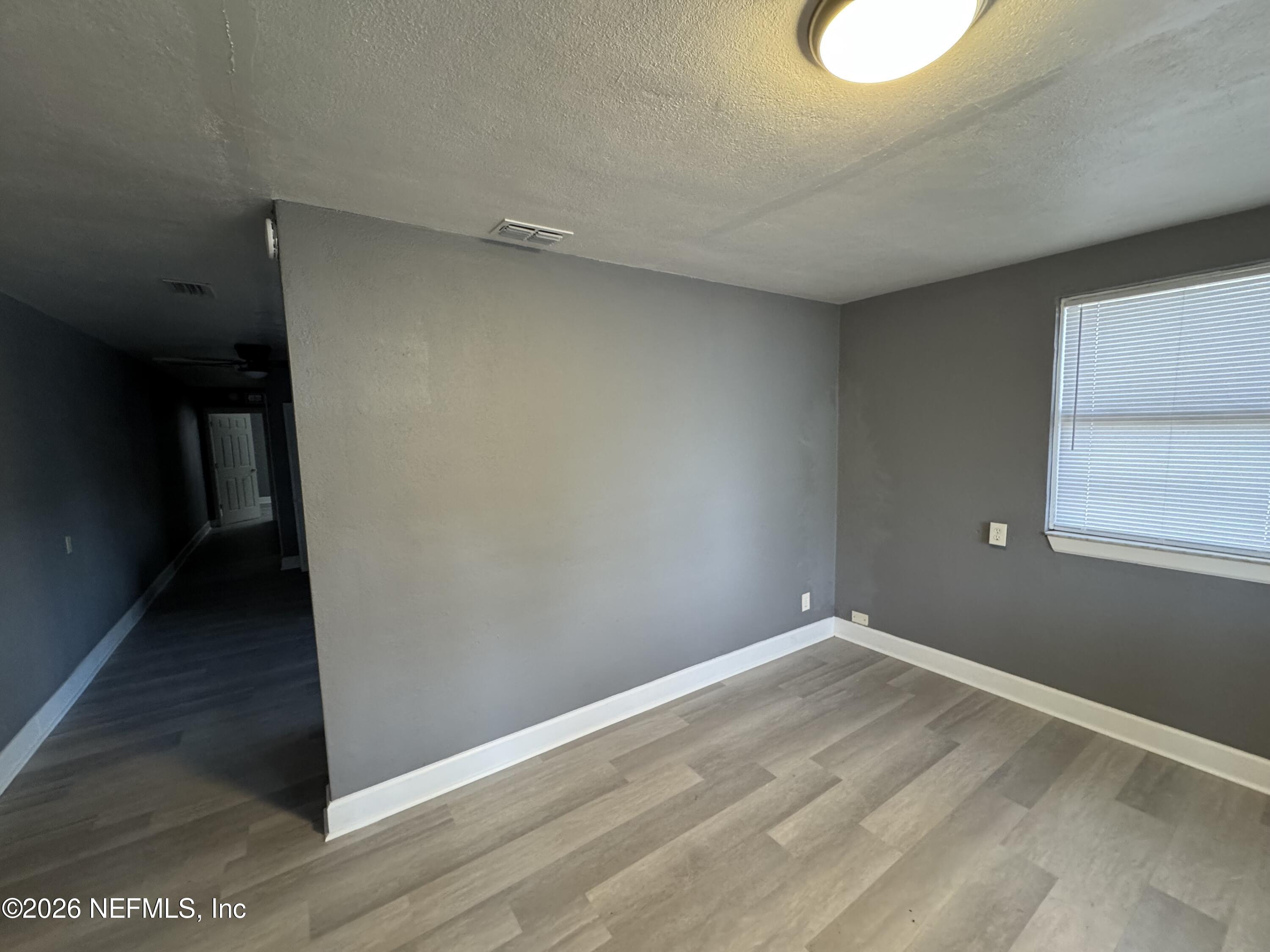 4114 Moncrief Road Jacksonville, FL 32209 - Photo 27 of 42 a view of a room with wooden floor and small window