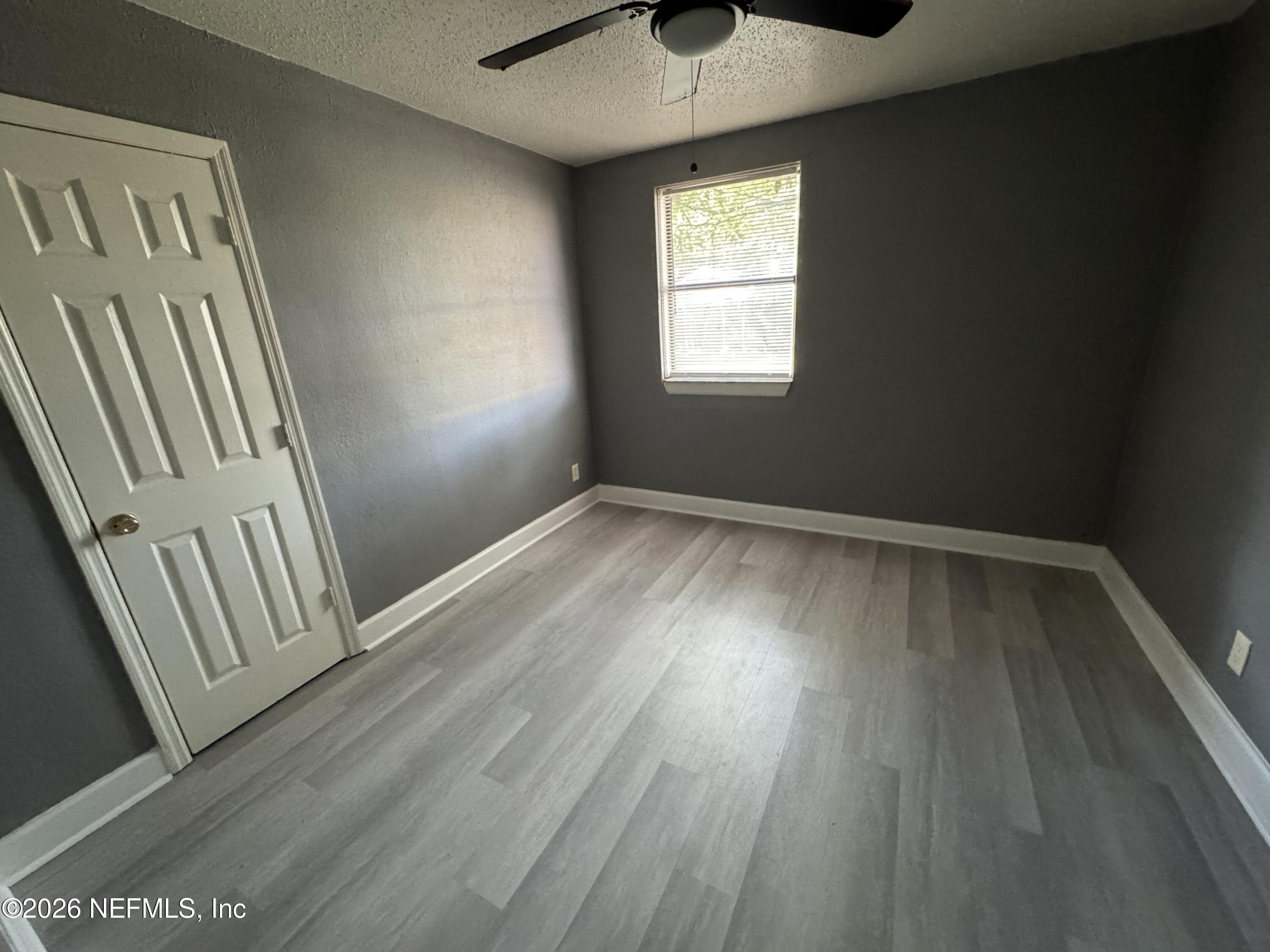 4114 Moncrief Road Jacksonville, FL 32209 - Photo 42 of 42 a view of an empty room with wooden floor and a window