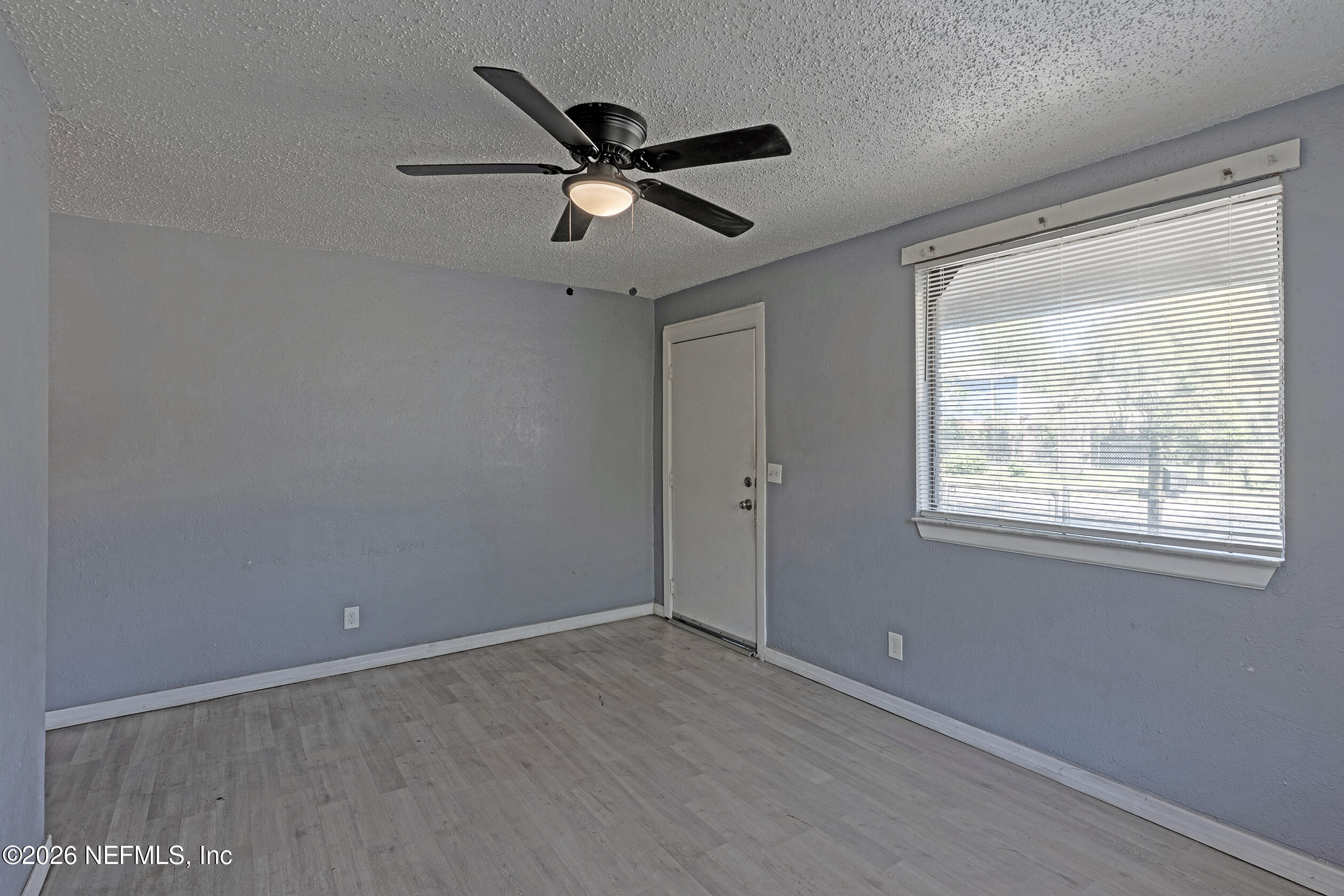 4114 Moncrief Road Jacksonville, FL 32209 - Photo 7 of 42 a view of a big room with wooden floor closet and windows