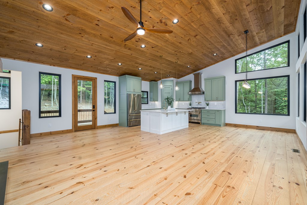 221 Goldmine Road Morganton, GA 30560 - Photo 16 of 51 a view of an empty room with a kitchen and windows