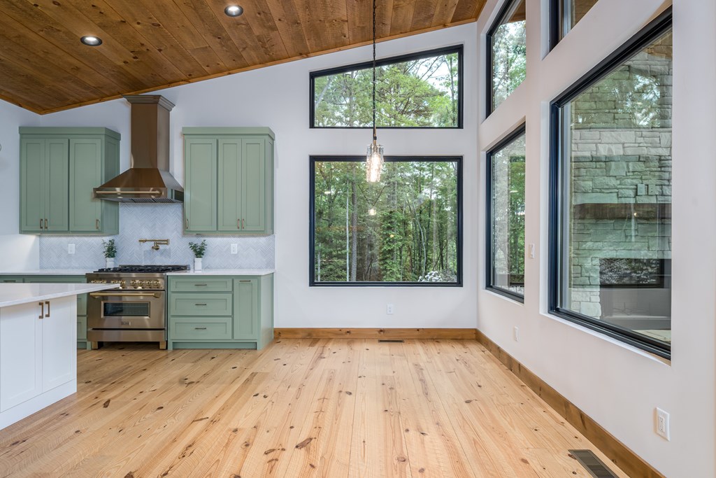 221 Goldmine Road Morganton, GA 30560 - Photo 17 of 51 a kitchen with a wooden floor and a large window