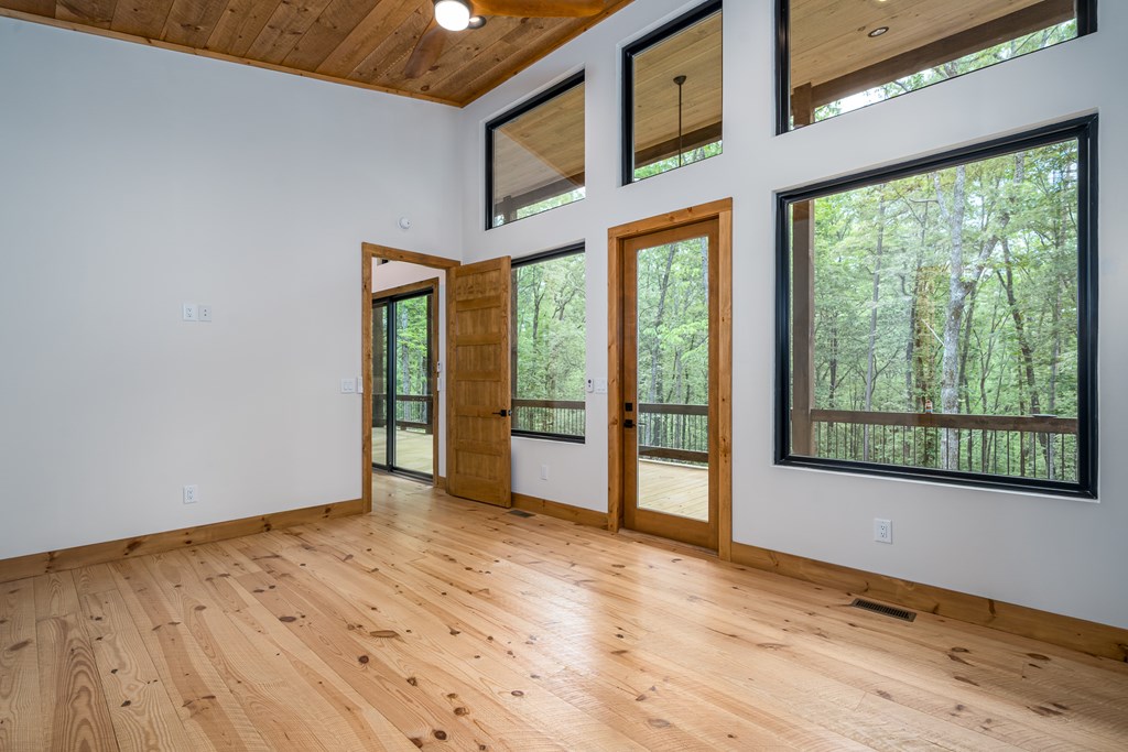 221 Goldmine Road Morganton, GA 30560 - Photo 23 of 51 a view of an empty room with wooden floor and a window