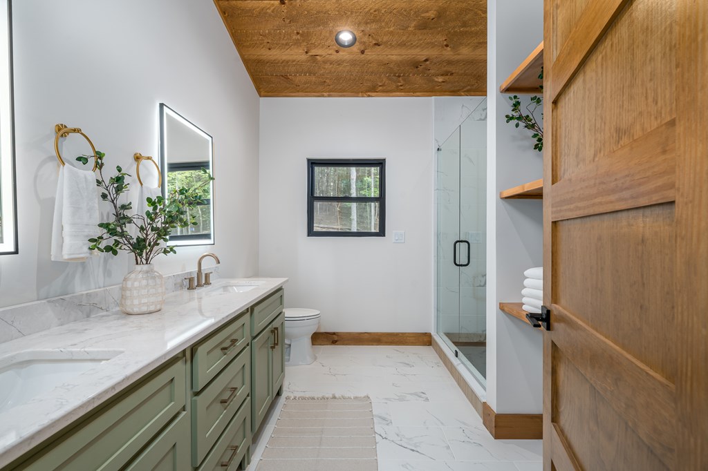 221 Goldmine Road Morganton, GA 30560 - Photo 24 of 51 a bathroom with a granite countertop sink a mirror and shower