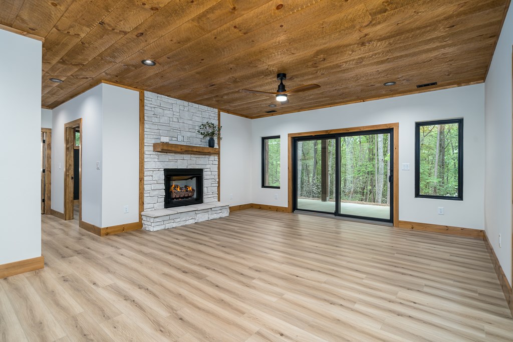 221 Goldmine Road Morganton, GA 30560 - Photo 31 of 51 a view of an empty room with wooden floor fireplace and a window