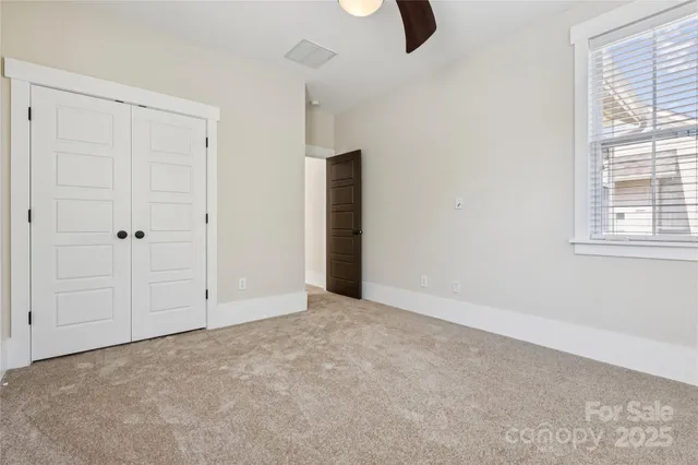 an empty room with windows and closet