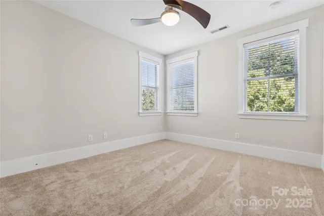 a front view of a house with a garden and plants