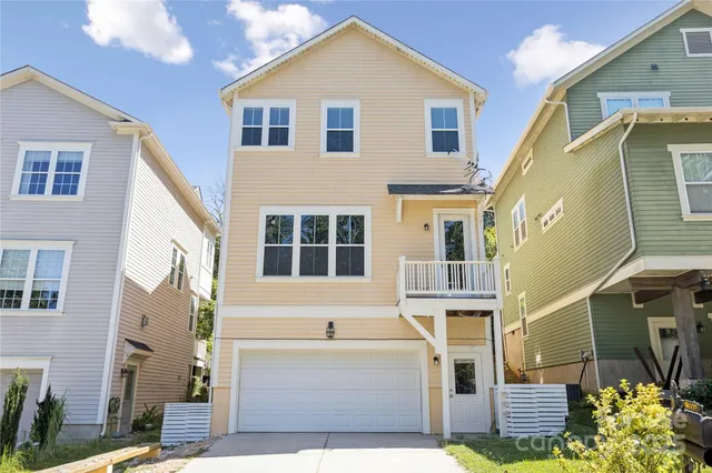 a view of a house with a yard and lake view