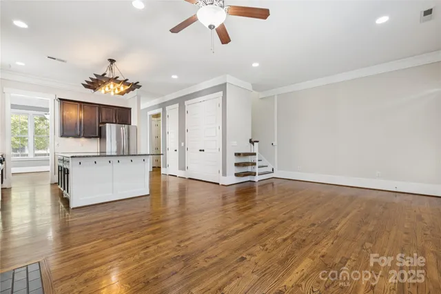 a kitchen with stainless steel appliances granite countertop a sink a stove and a refrigerator