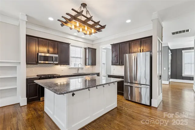 a kitchen with a stove sink and refrigerator