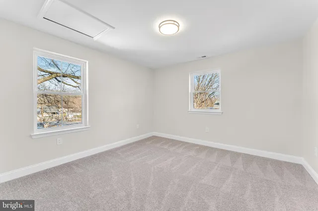 an empty room with windows and closet