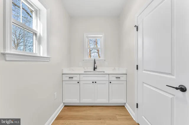 a spacious bathroom with a sink and a mirror