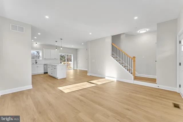 a view of kitchen and hall with wooden floor