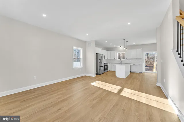 a view of kitchen and hall with wooden floor