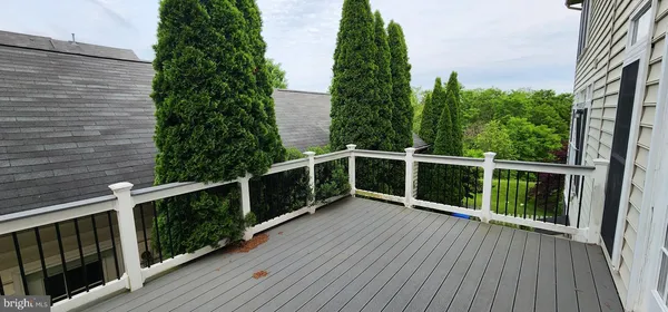 a view of balcony with wooden floor and fence