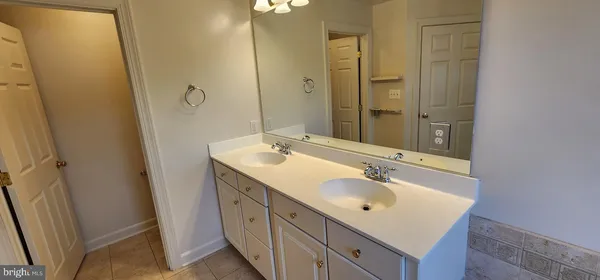 a bathroom with a sink a mirror and a shower