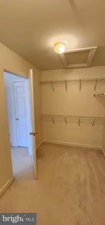 a view of an empty room and wooden floor