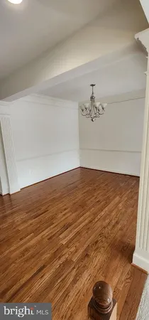 a view of a livingroom with an empty space and a window
